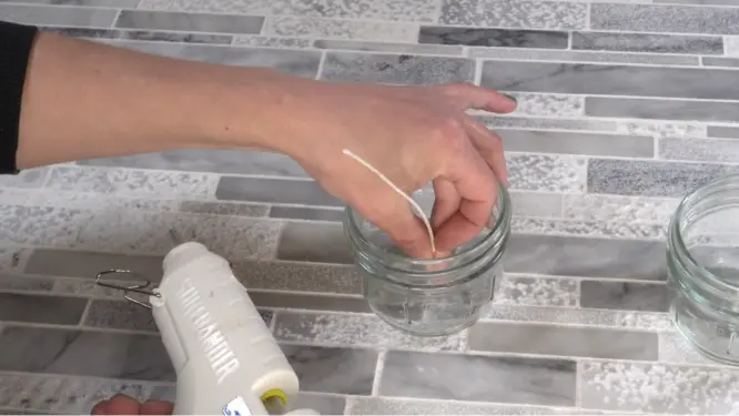 centering candle wick in mason jar with hot glue