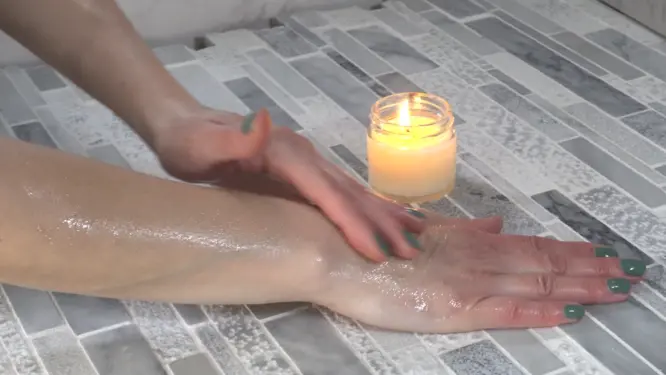 close up of silky massage candle oil texture on skin