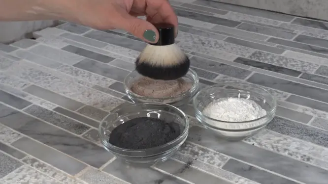 dipping brush into dry shampoo