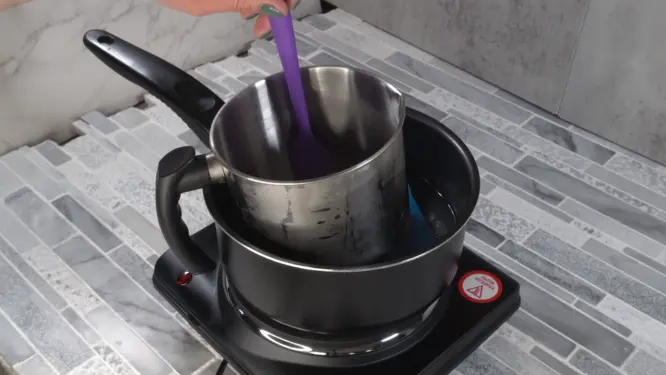 melting soy wax and butters in double boiler for massage candle