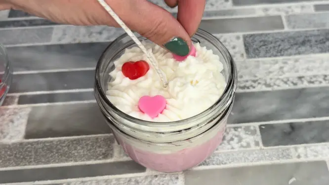 placing heart embeds into whipped candle wax topping