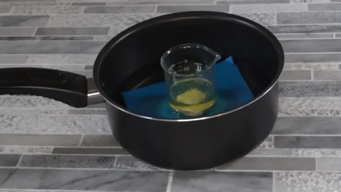 placing heat phase ingredients on a double boiler for lip gloss