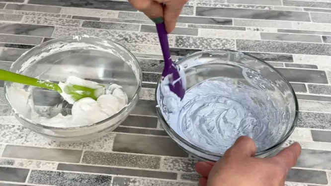 whipped soap divided into two bowls white and blue before piping