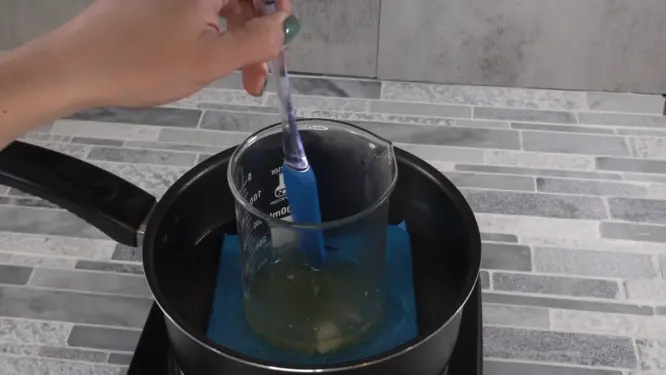 Melting solid butters and wax in a double boiler while stirring