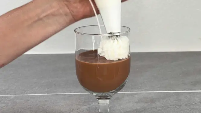Piping whipped wax topping onto candle like frosting