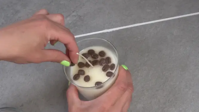 Placing coffee embeds on candle top