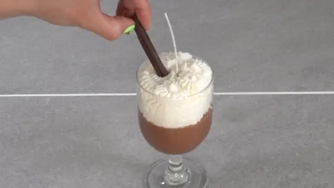 placing a cinnamon stick in candle