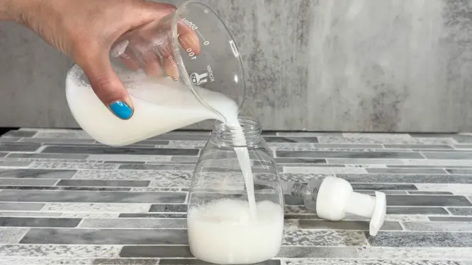 pouring DIY hand soap into foaming bottle