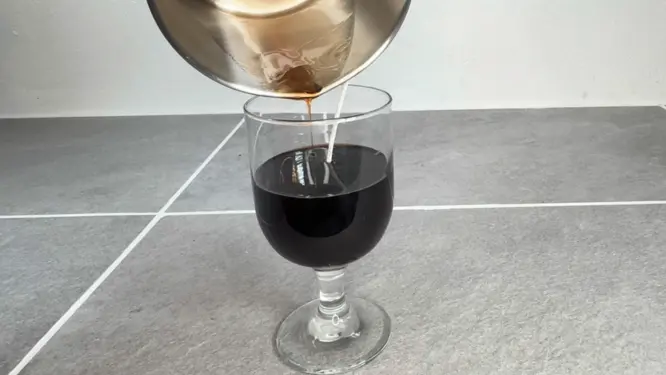 pouring wax into candle jar to make coffee candle