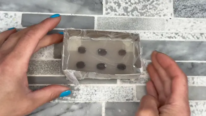 tapping mold on counter to release bubbles from silicone