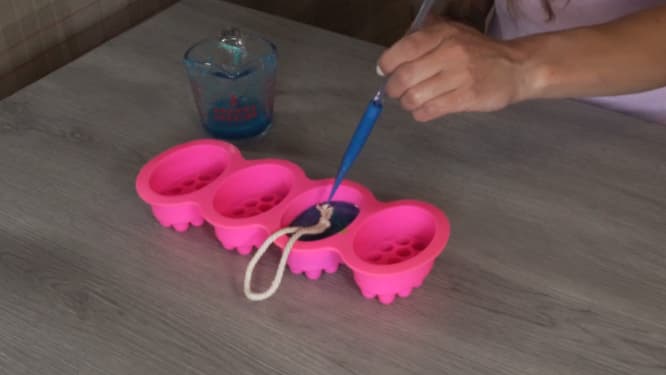 placing cotton rope into melt and pour soap