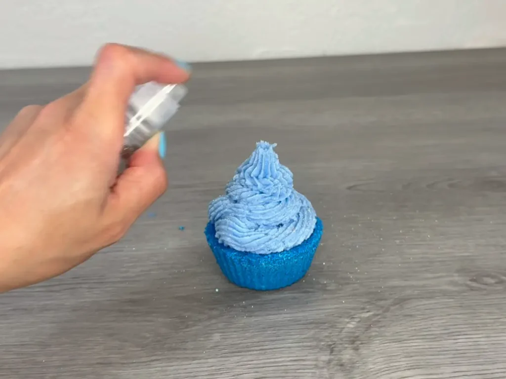 Putting glitter on bath bomb cupcake