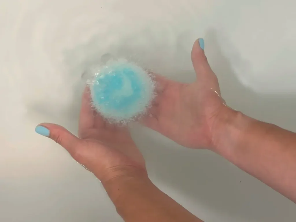 placing the finished bath bomb in the tub