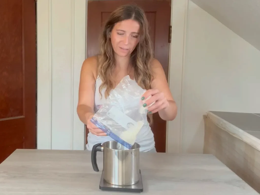adding soy wax into pouring pot