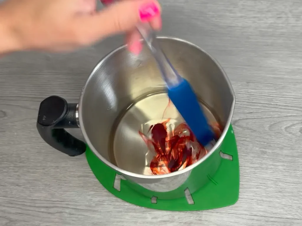 mixing candle colorant into melted wax
