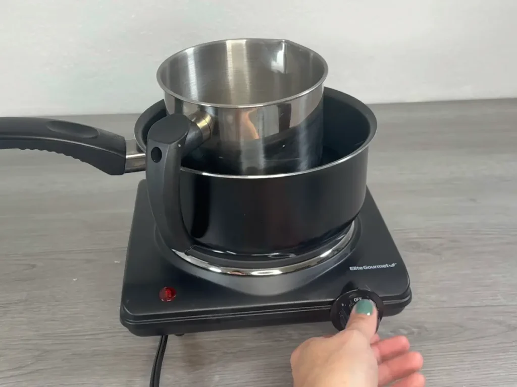 placing pouring pot on a double boiler