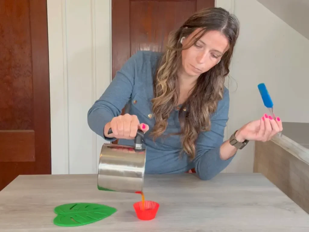pouring candle wax into silicone mold