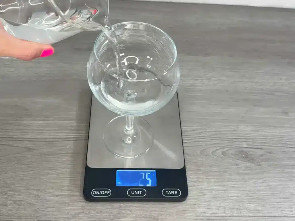 pouring water into candle container
