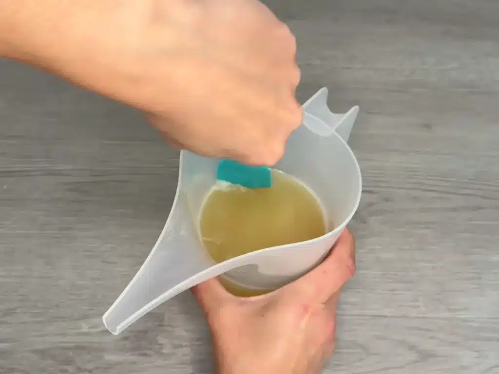 scraping edge of container to get wax off