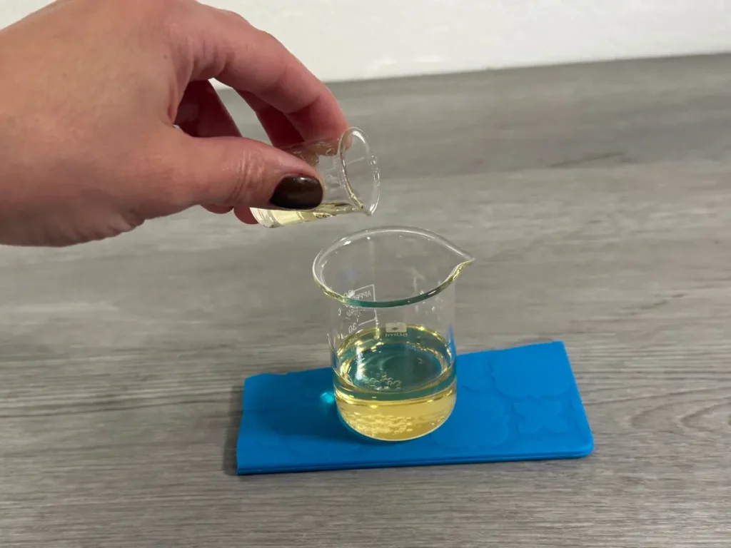 adding fragrance oil to melted soy wax