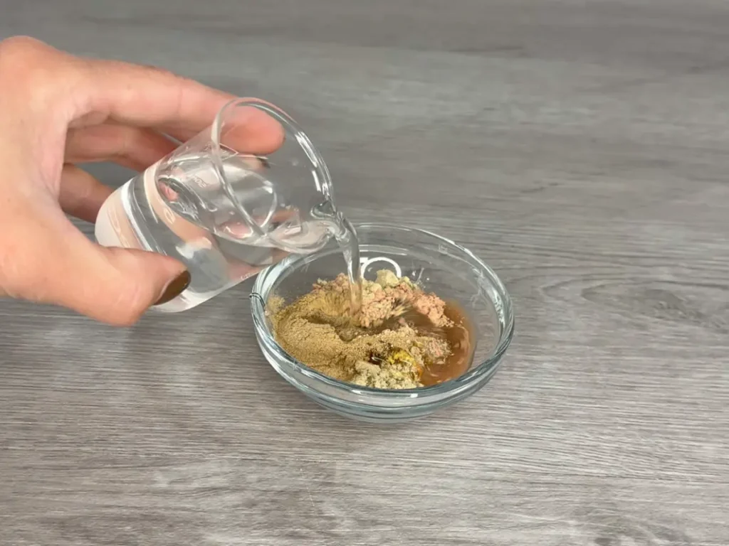 adding water to hydrate clay face mask