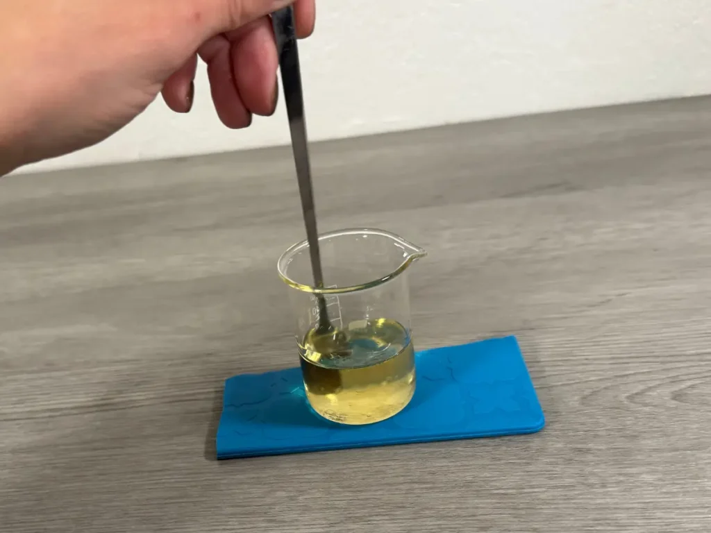 mixing fragrance oil into candle wax