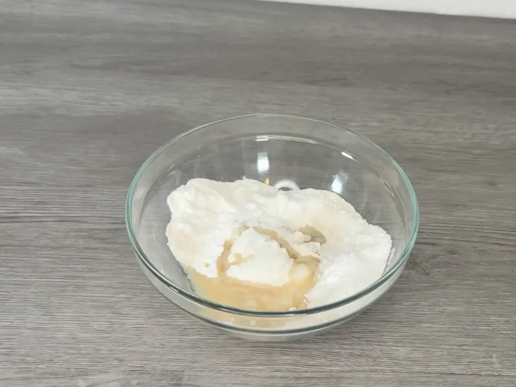 mixing shower steamer dry ingredients in a bowl with fragrance oil