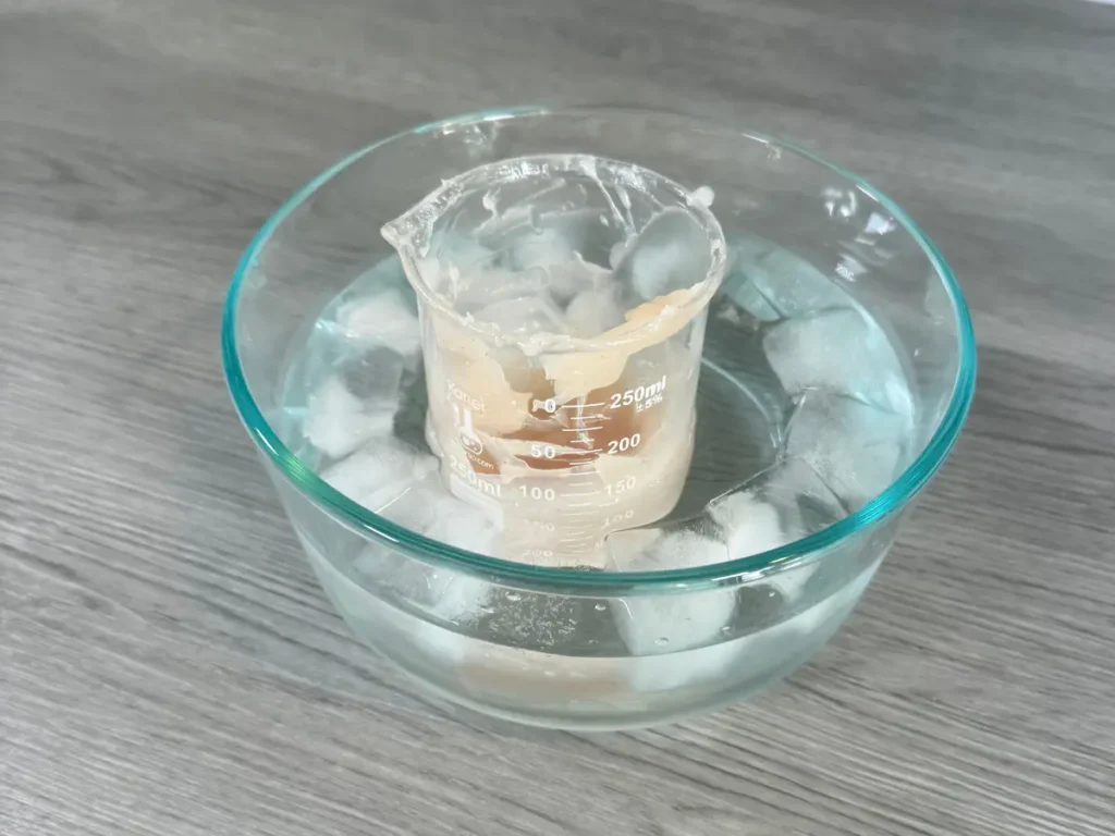 rapidly cooling body butter in an ice bath to prevent graininess in it