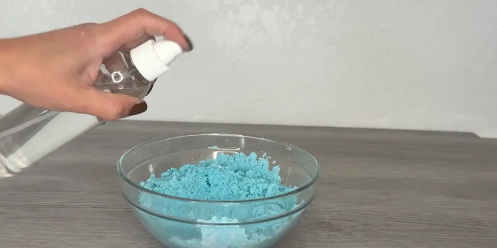 spraying shower steamer with rubbing alcohol