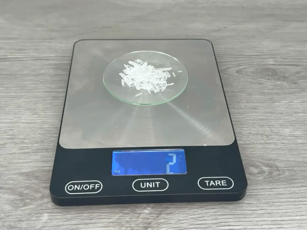 weighing menthol crystals for shower steamer