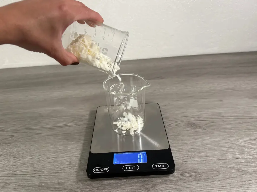 weighing soy wax to make a candle